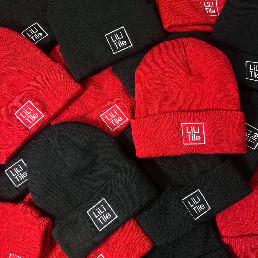 Red and black Lili Tile beanies with embroidered logos