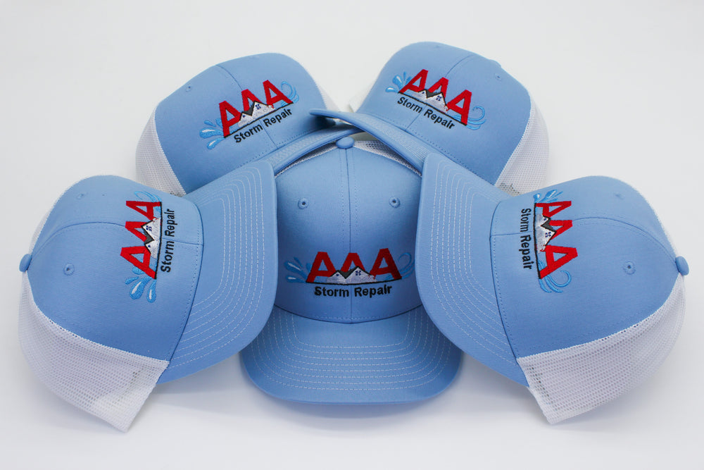 A batch of embroidered AAA Storm Repair caps